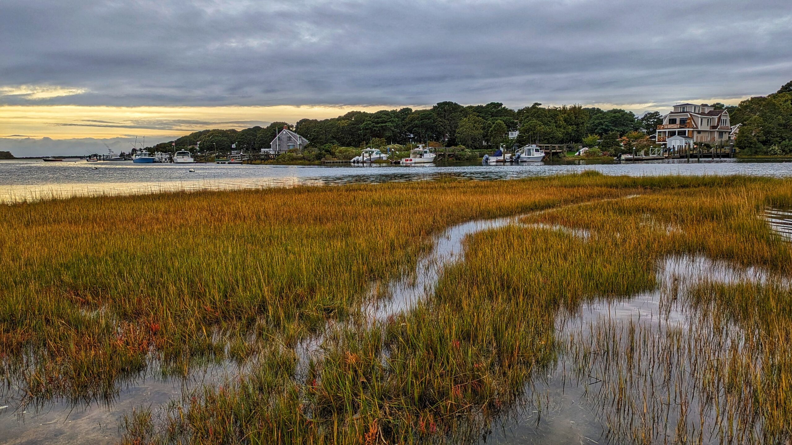 Salt marsh and waterfront homes along the shoreline in Mashpee, Massachusetts, on Cape Cod.